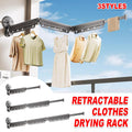 Retractable clothes drying rack with clothes hanging on it, set against a blue sky background.