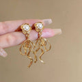 French Retro Gold Tone Long Drop Earrings with Pearl Accent and Swirl Design - view 4