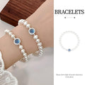 Imitation Pearl Stretch Bracelet with Blue Centre Gemstone - White
